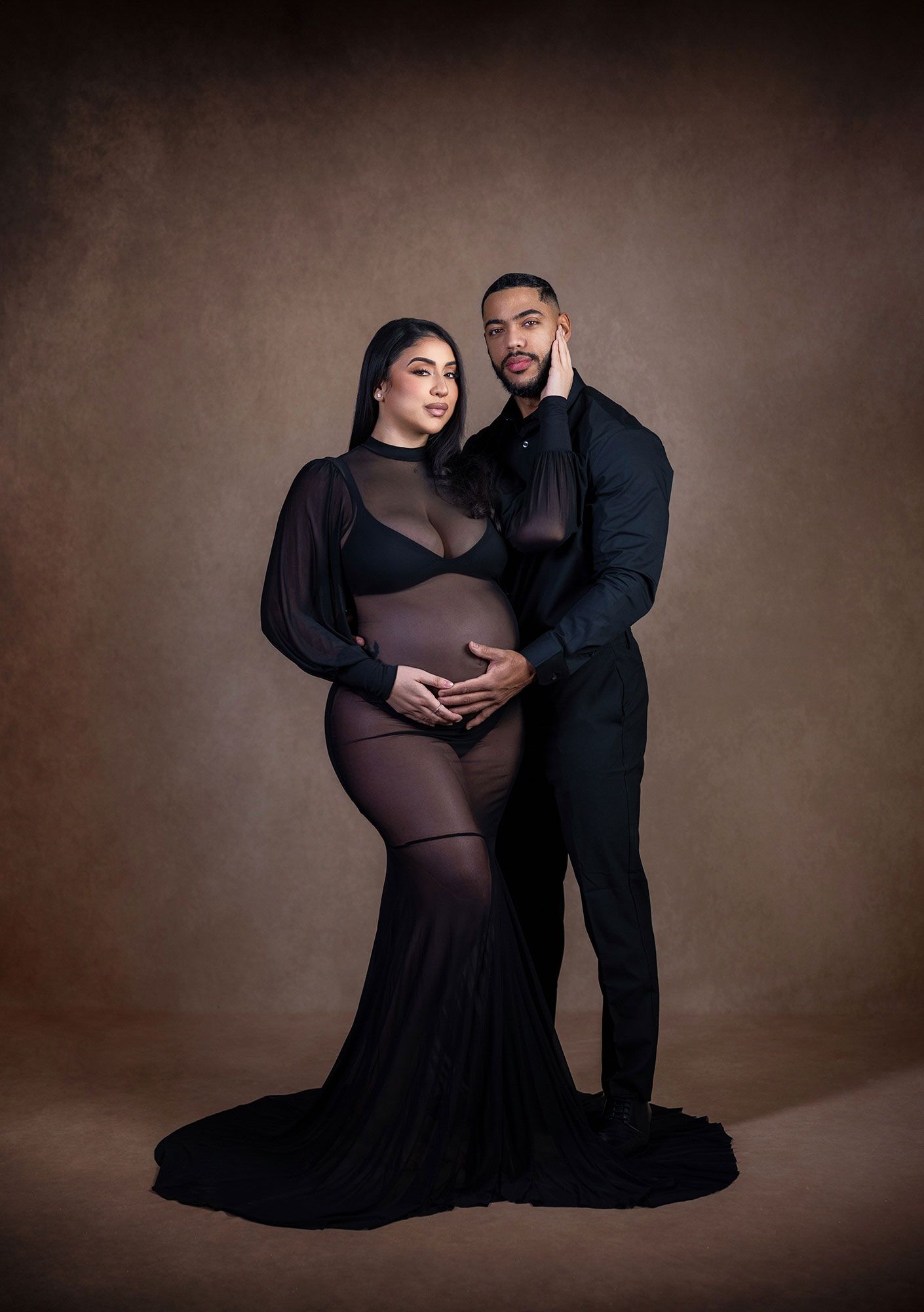 A maternity photoshoot series showing a couple in black attire against a dark brown backdrop in various intimate poses.