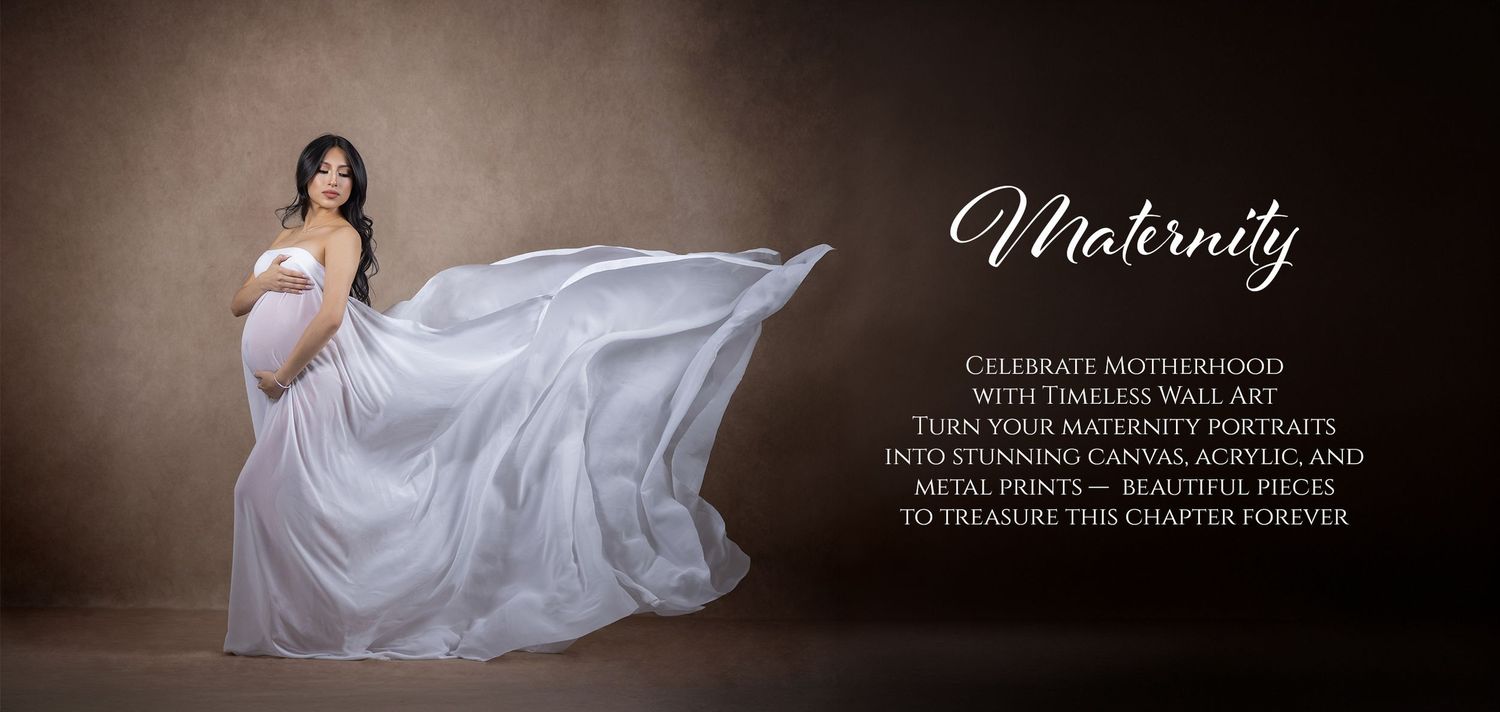 Pregnant woman in flowing white gown poses gracefully for maternity wall art photography session.
