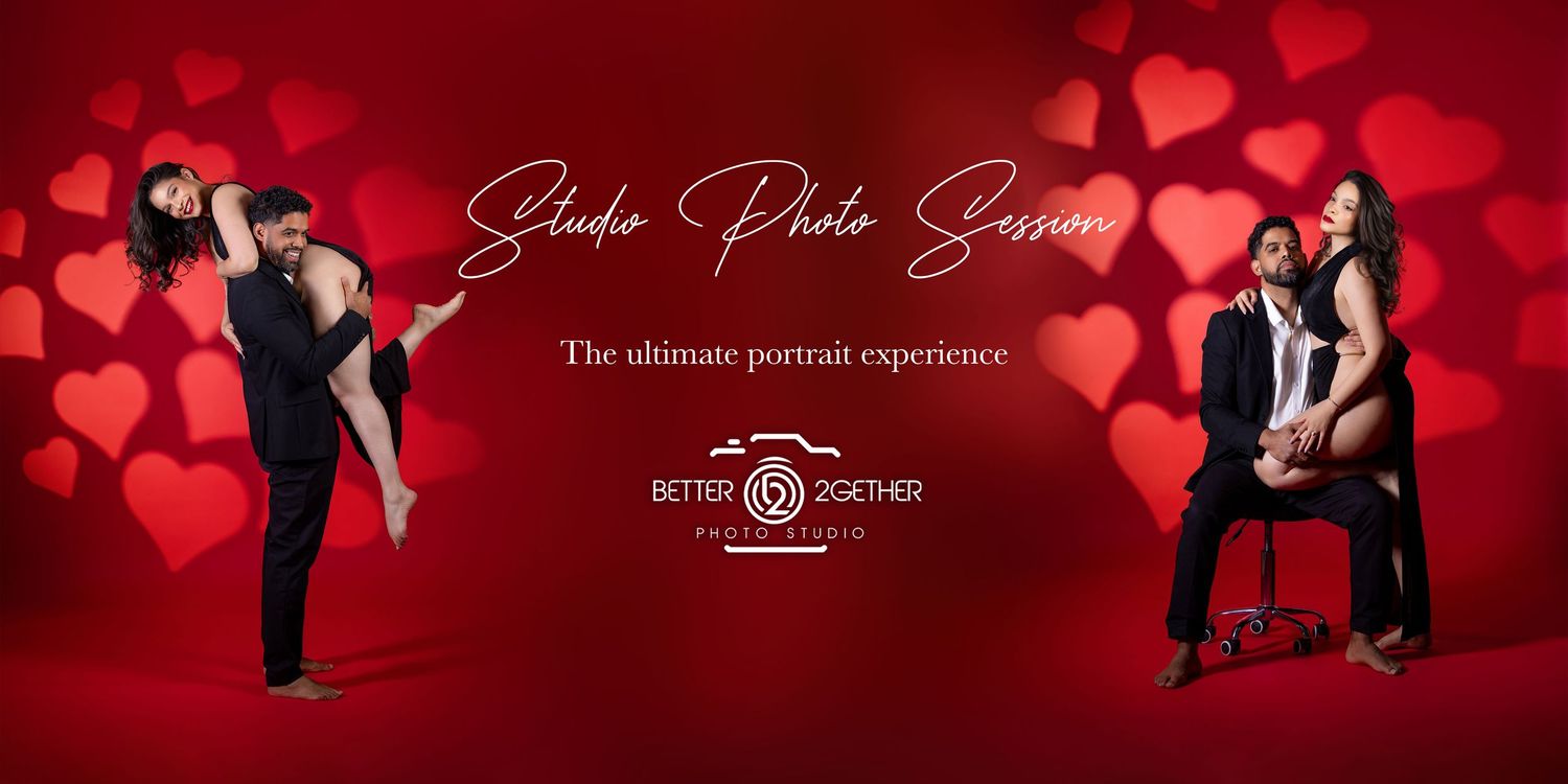 Couple poses for a romantic Valentine's Day studio photo session with red heart backdrop for Better Together Photography.