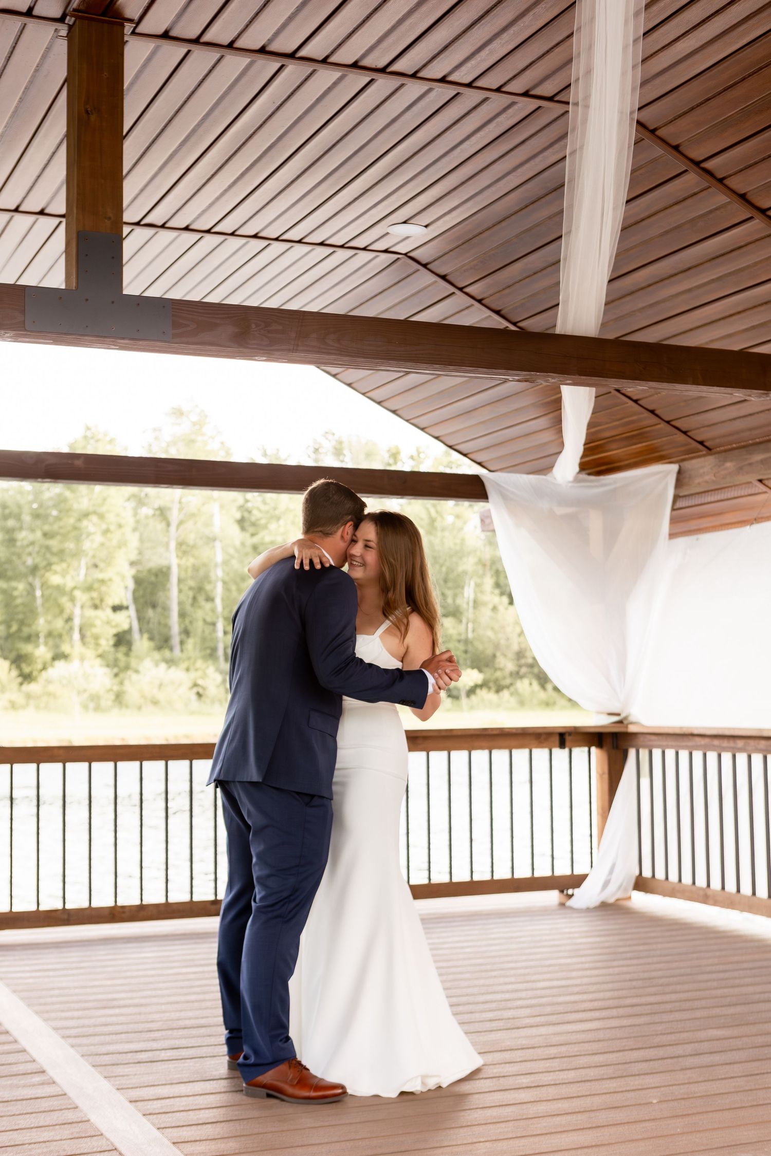 Bride and groom first dance on a dock over a pond in Columbus Ohio