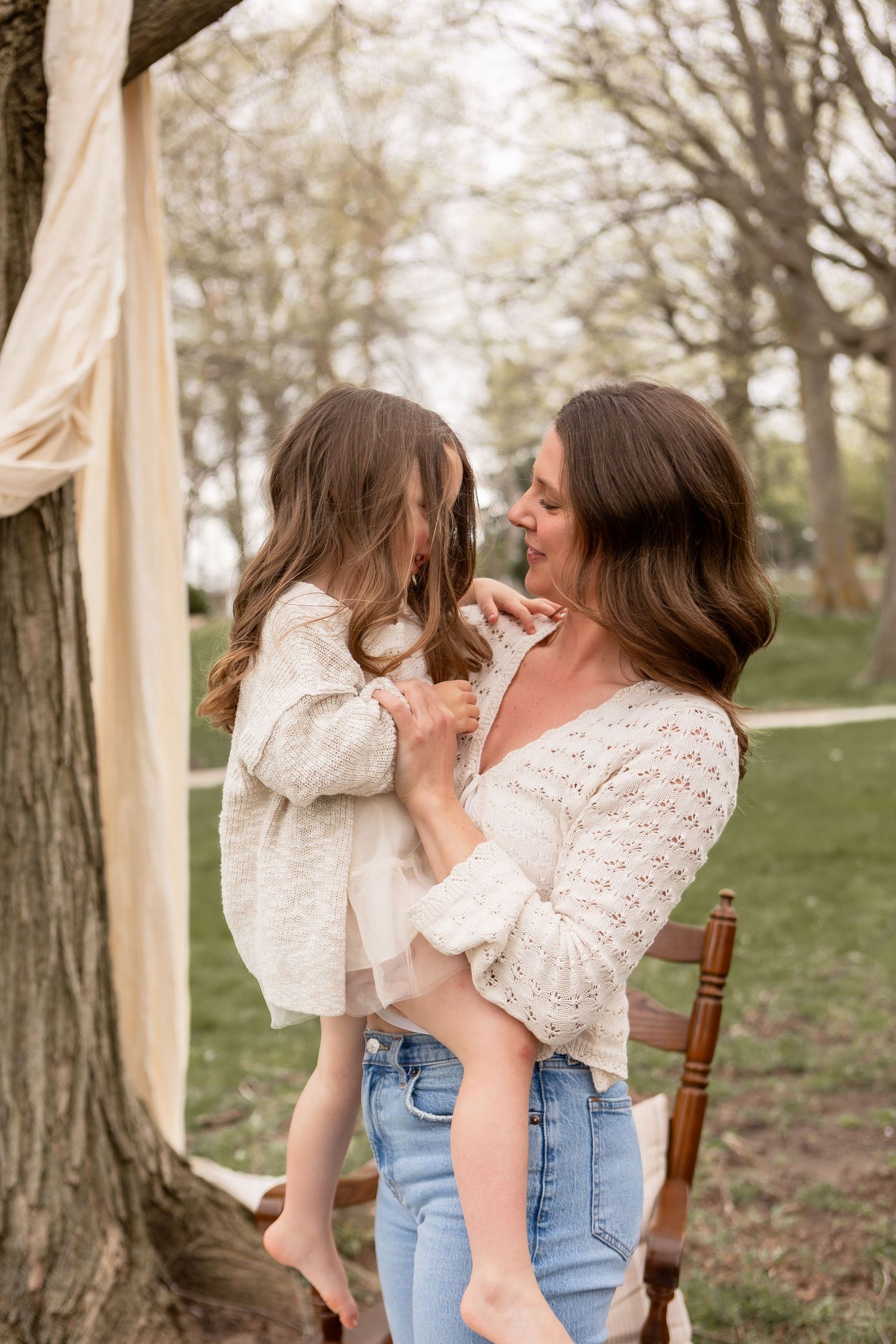 Mother and daughter dancing under a tree in the park in Columbus Ohio