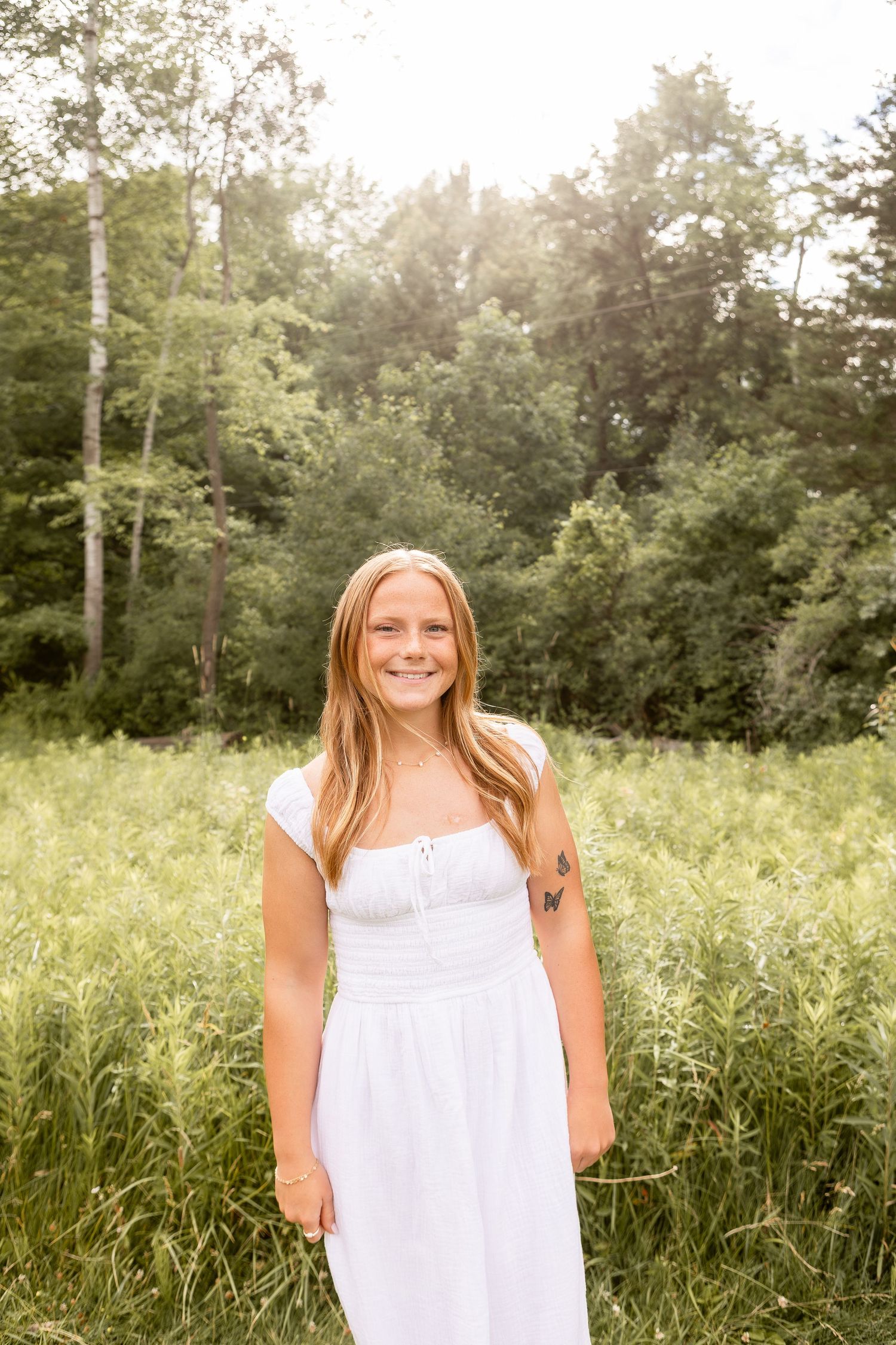 Girl in white dress standing beside grassy field in Columbus Ohio