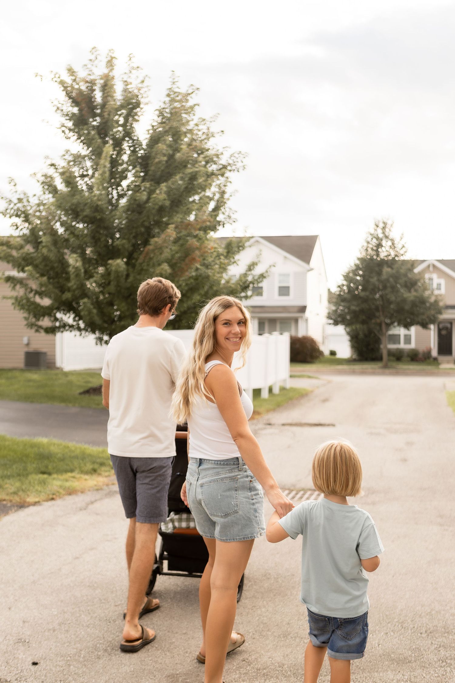 Family of four going for a walk with the mother looking back smiling in Columbus Ohio