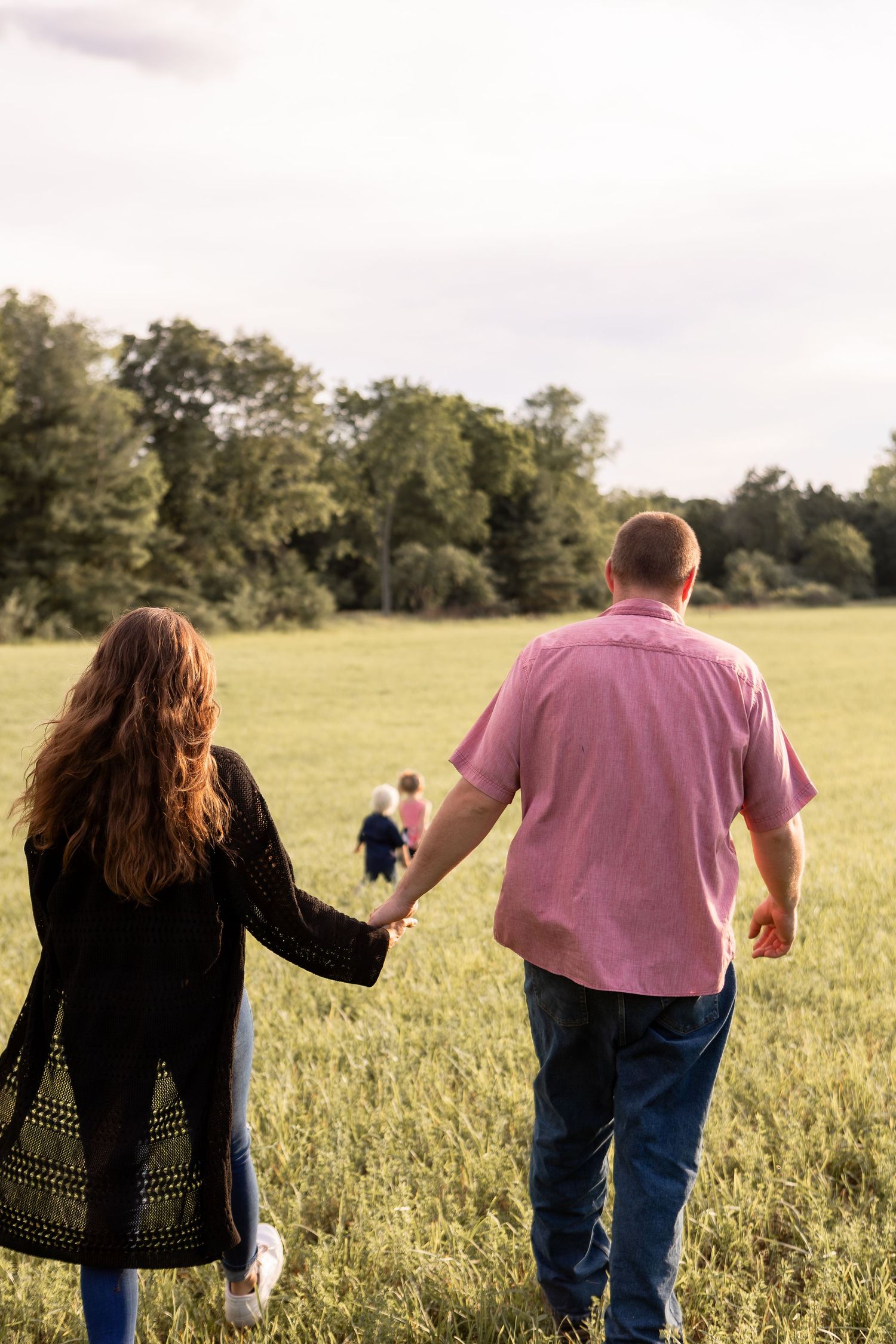 Family of four walking in a field in Columbus Ohio