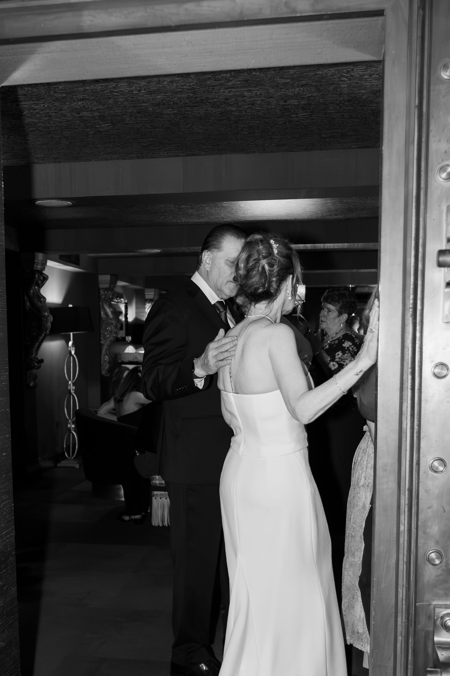 Bride and groom embracing and greeting guests inside bank vault in Columbus Ohio