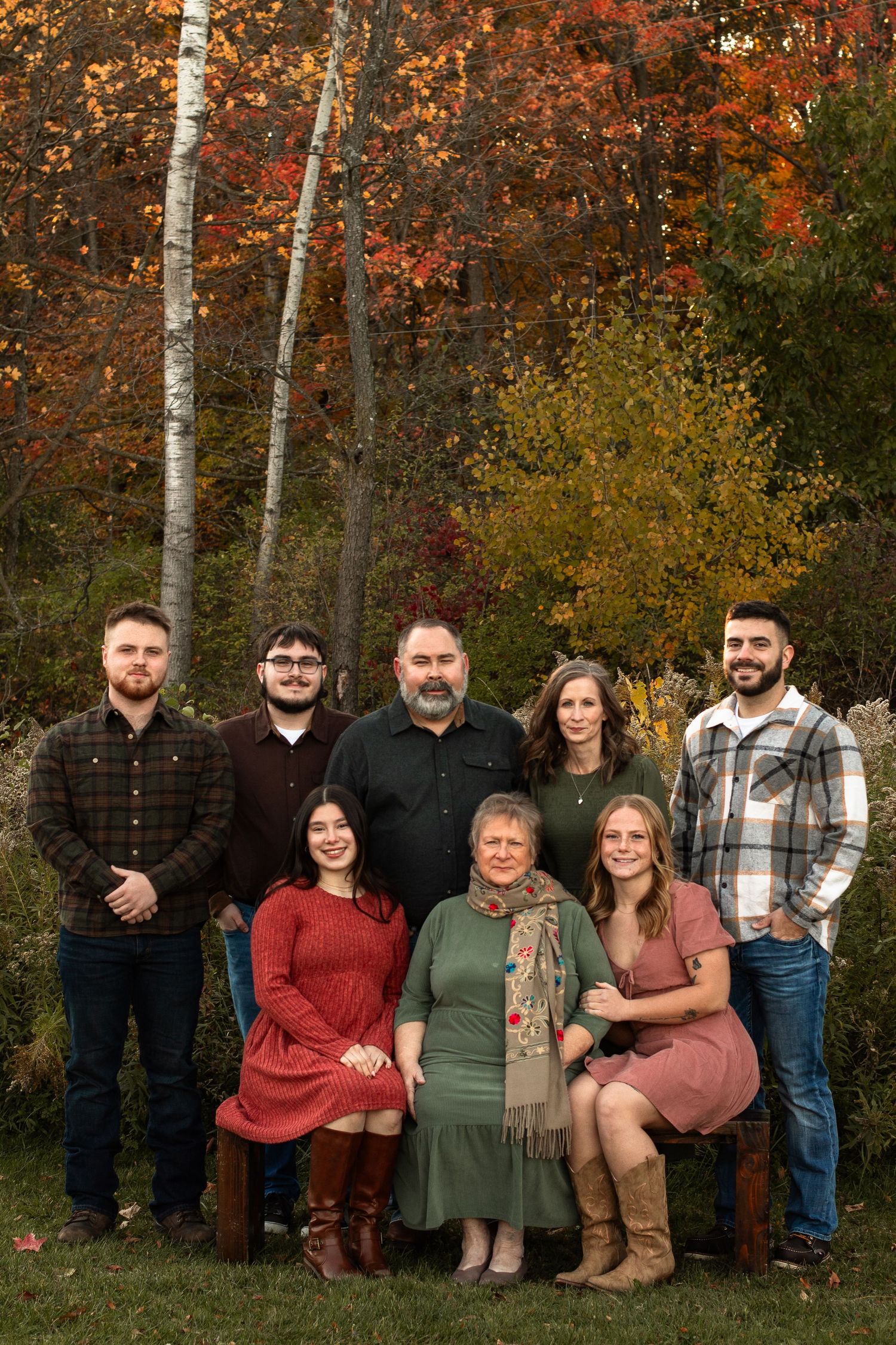 Generational family photos of 8 sitting on a bench and standing behind in the fall in Columbus Ohio