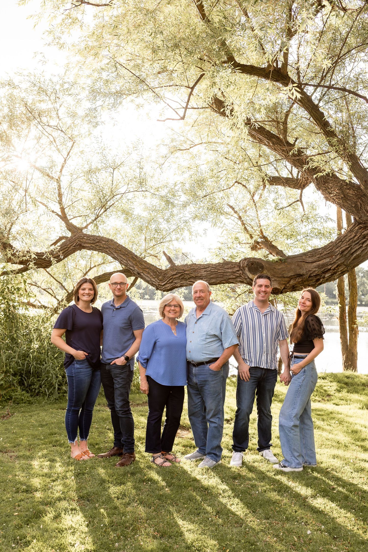 Extended family of couples and parents gathered by tree in shades of blue in Columbus Ohio