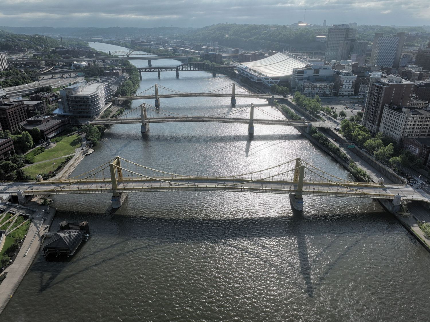 Aerial view of multiple bridges spanning the Allegheny River in Pittsburgh, Pennsylvania on a cloudy day.