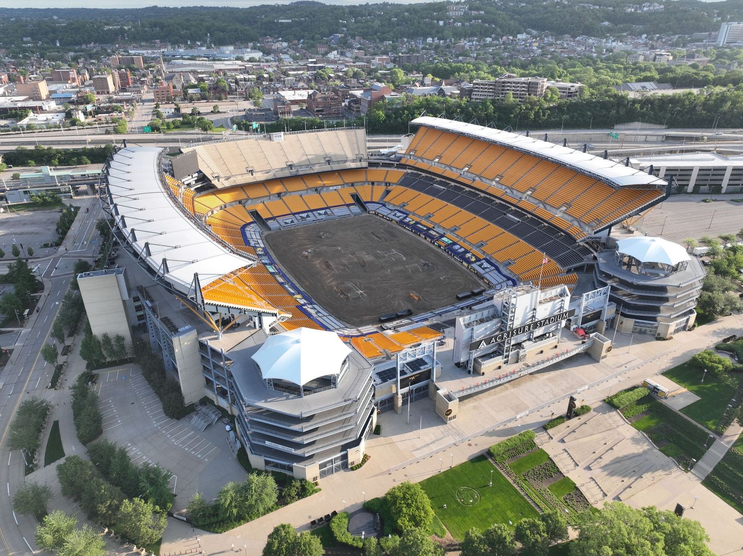 Aerial view of Acrisure Stadium, home of the Pittsburgh Steelers, showcasing its distinctive yellow seats.
