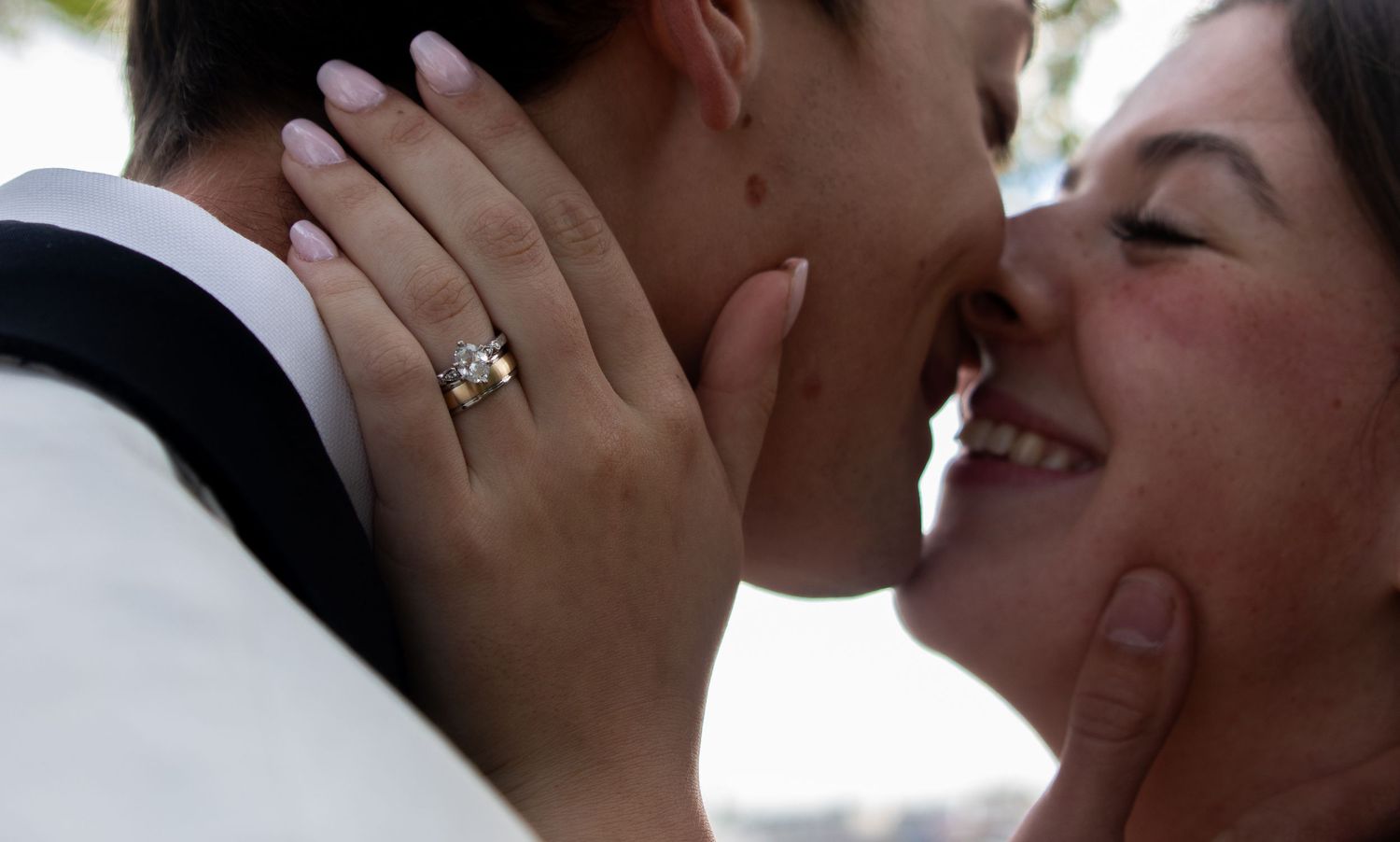 Close-up of a smiling bride and groom sharing a romantic moment on their wedding day.
