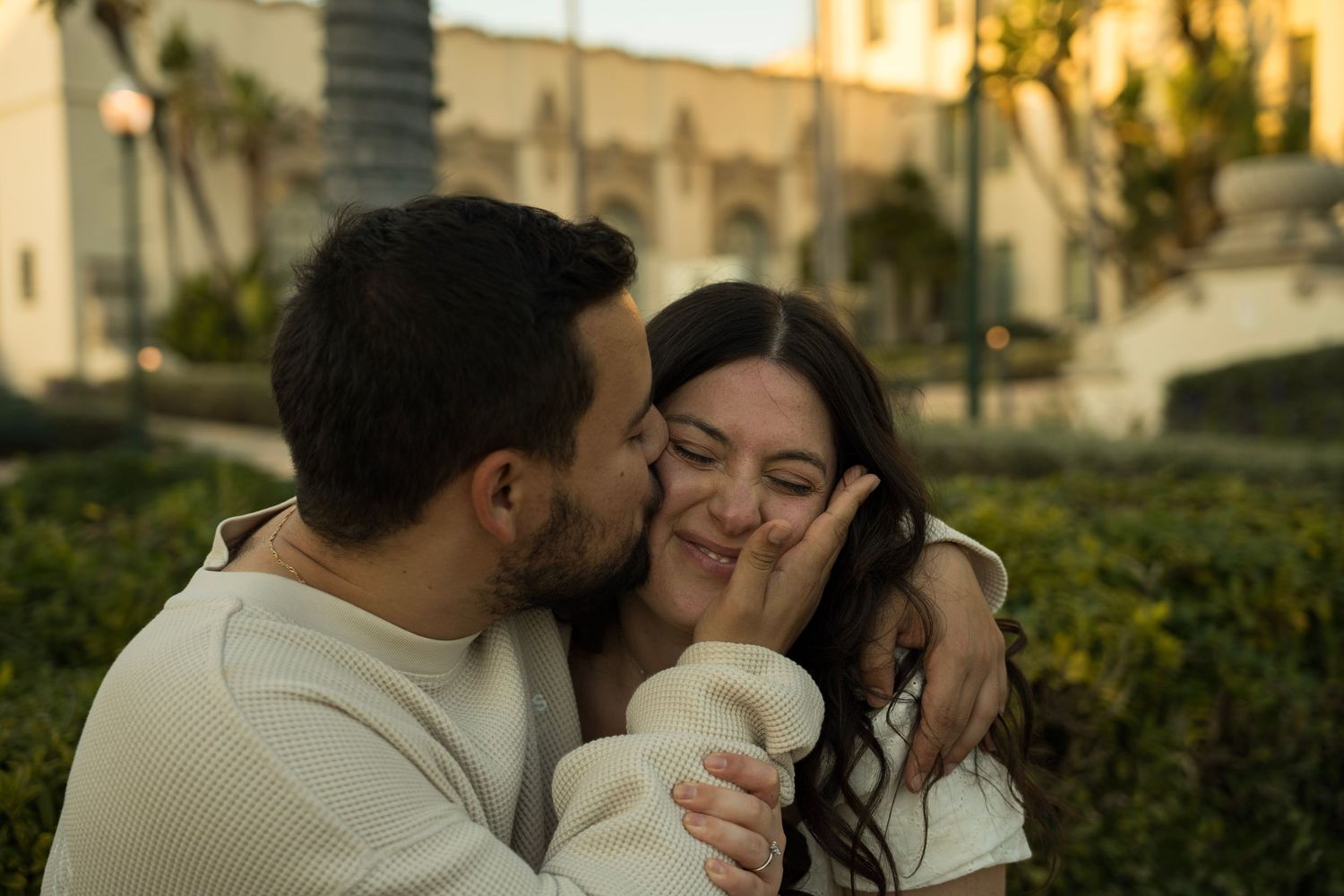 A husband kissing his wife's cheek