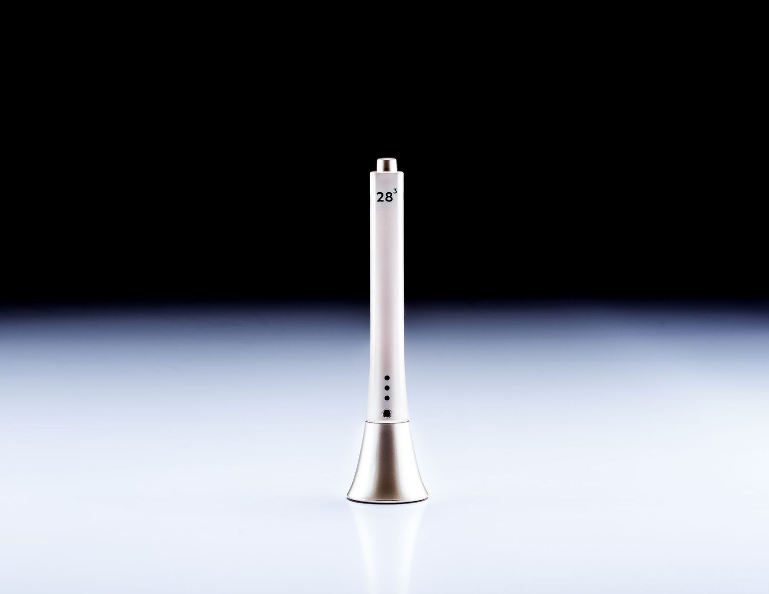 Sleek white and gold electronic beauty device pen standing upright against dark background.
