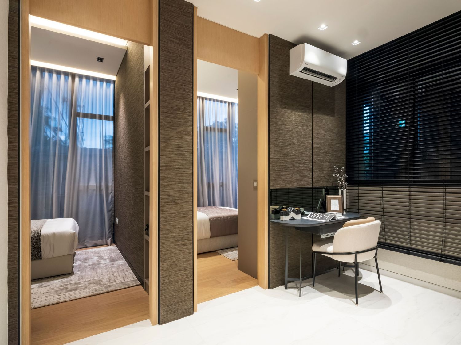Modern luxury bedroom suite with walk-in closet, vanity desk, wall-mounted AC unit, and elegant dark wood panel accents.