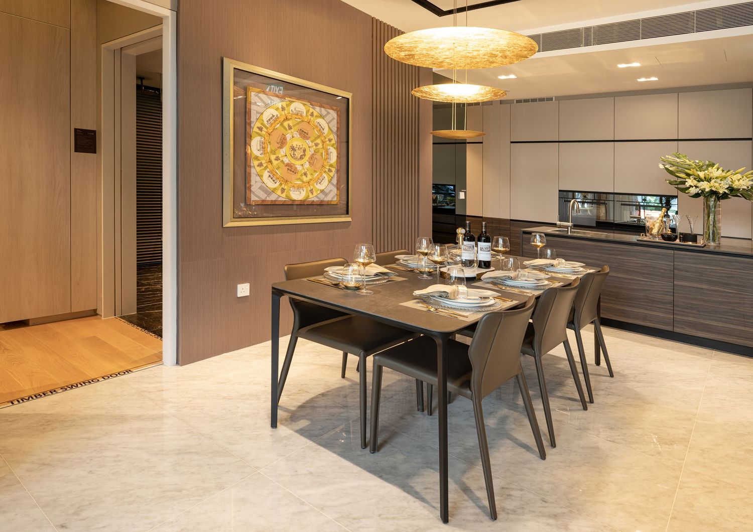 Modern dining room with a rectangular table, four chairs, pendant lighting, and colorful artwork on the wall.