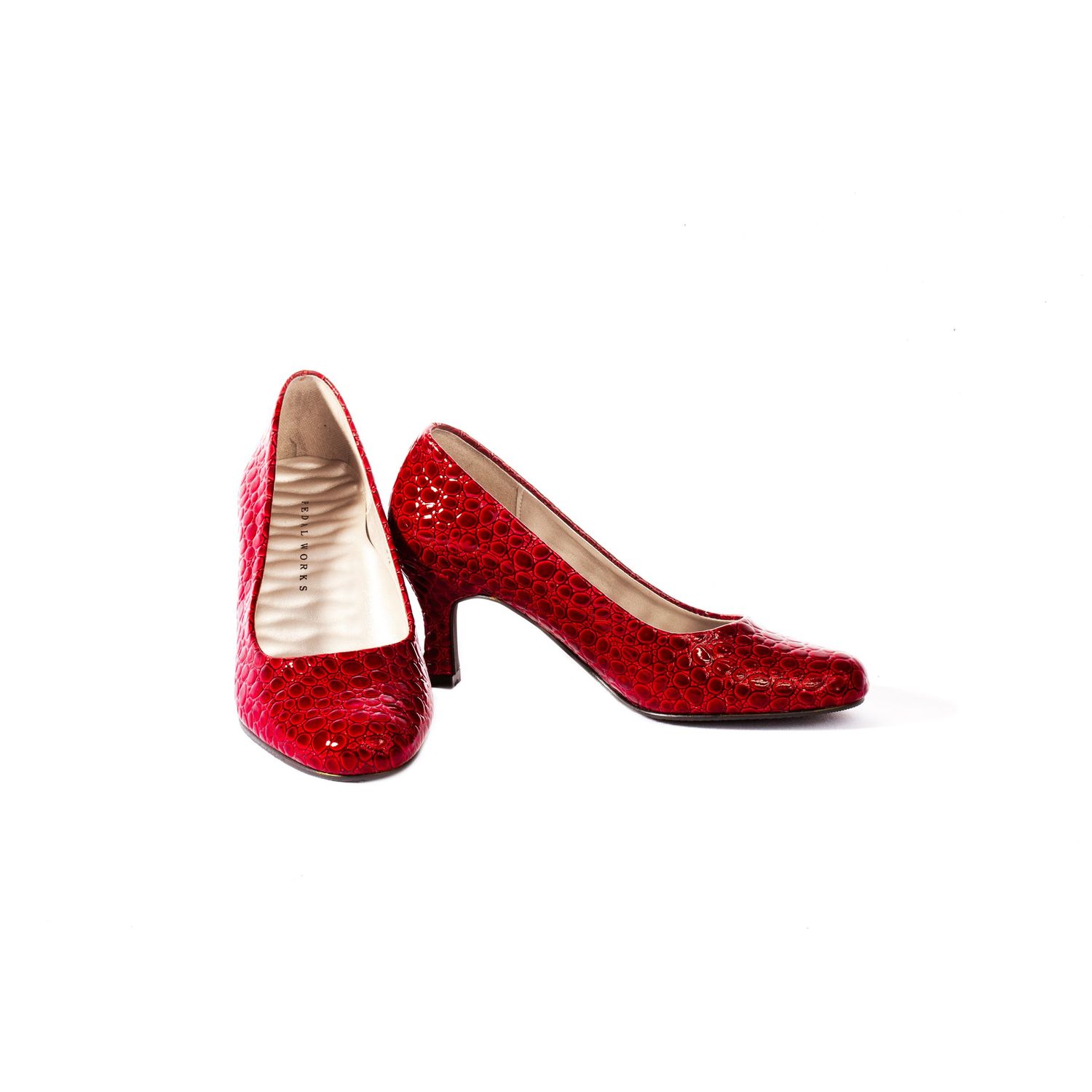 Elegant red sequined kitten heel pumps with crocodile texture on clean white background.