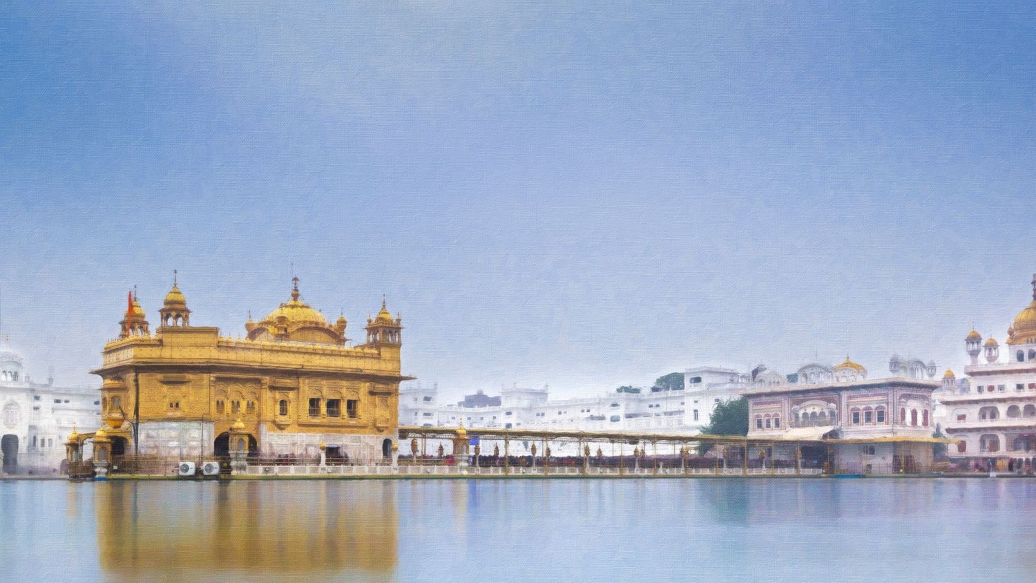Golden Temple gleaming in sunlight reflected on sacred pool in Amritsar, India.