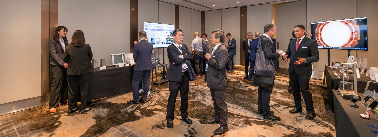 Business professionals networking in a modern conference room during a corporate event.