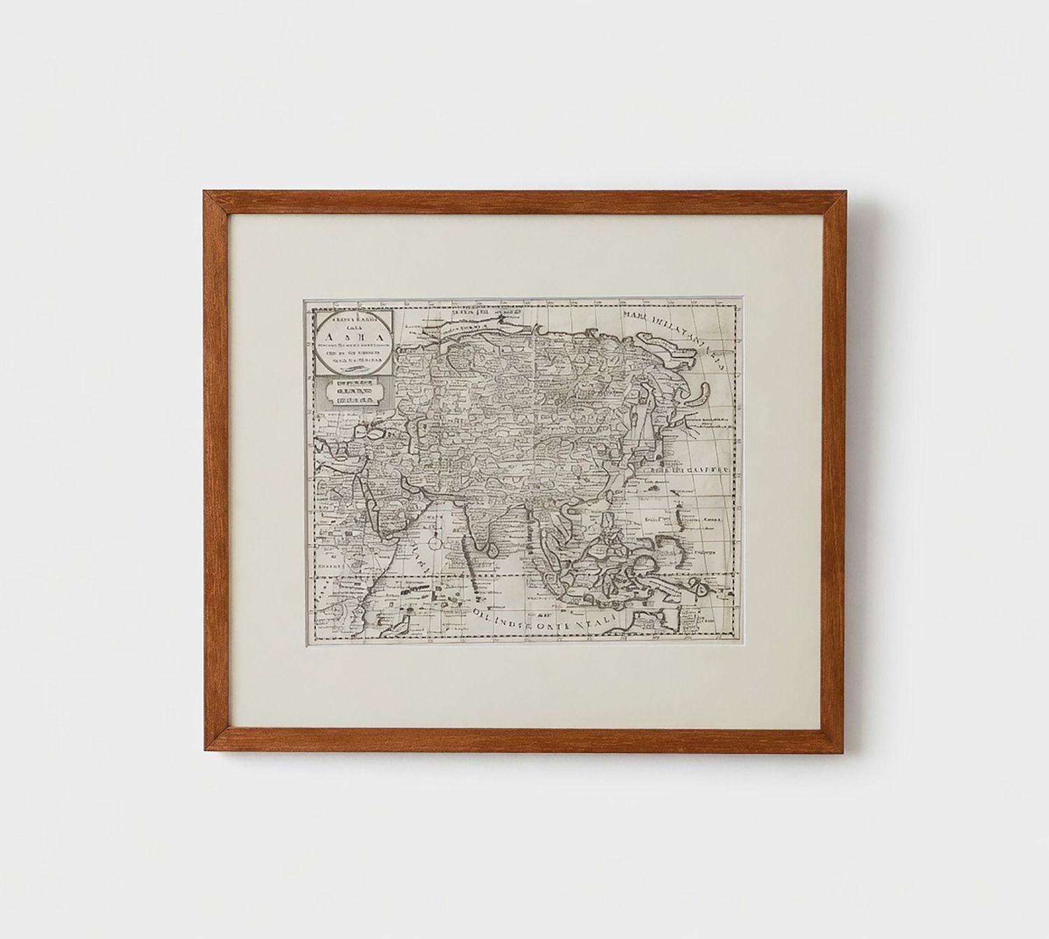 Antique map of Asia in wooden frame with white mat, featuring detailed cartography in sepia tones.