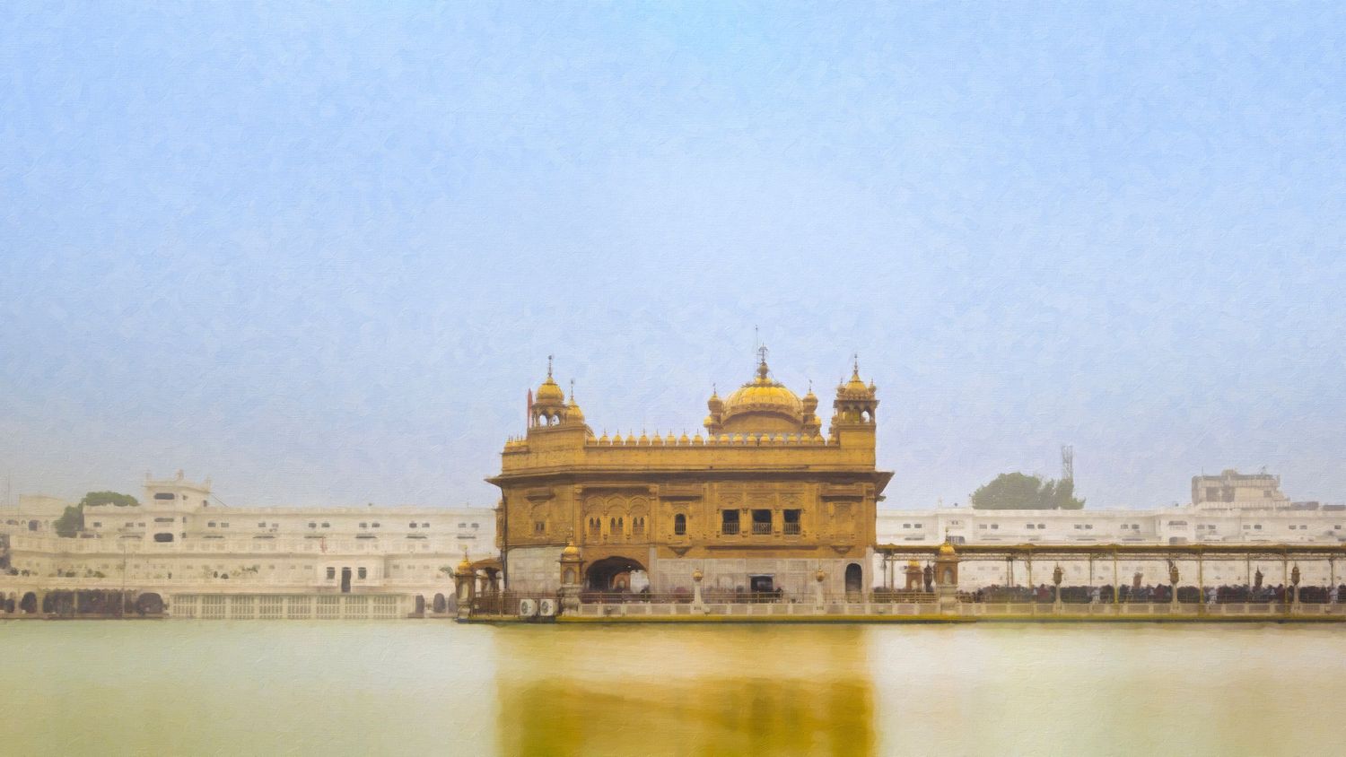 Golden Temple Harmandir Sahib reflecting in sacred Amritsar pool under hazy sky, Punjab India.