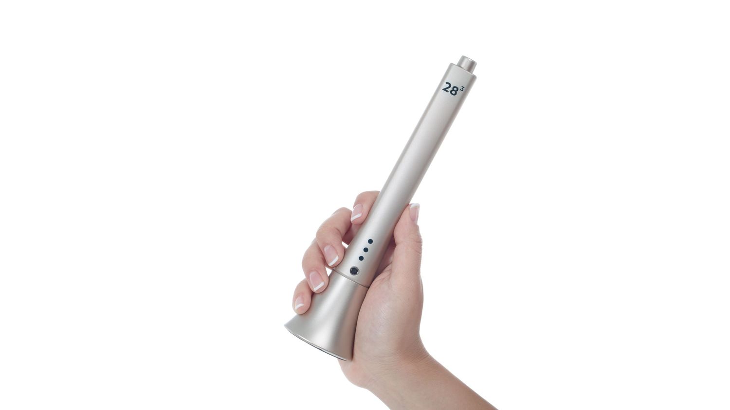 Hand holding a sleek silver handheld beauty device against white background.