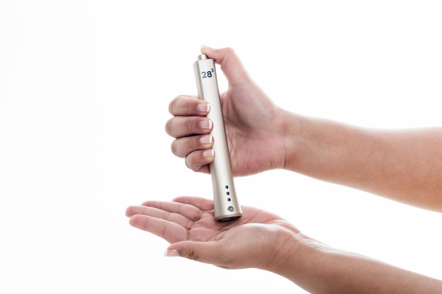 Hands holding a sleek silver insulin pen injector against a white background.