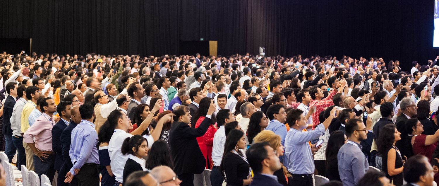 Large audience of diverse attendees gathered at an international conference or summit event.