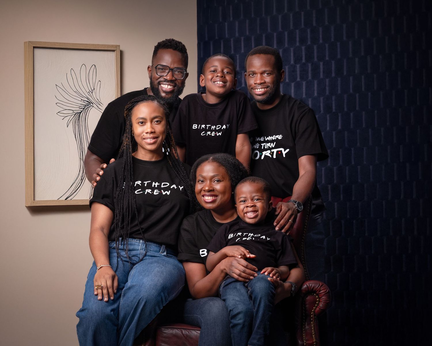 Family of five wearing matching Birthday Crew black t-shirts posing together for a milestone 40th birthday celebration photo.