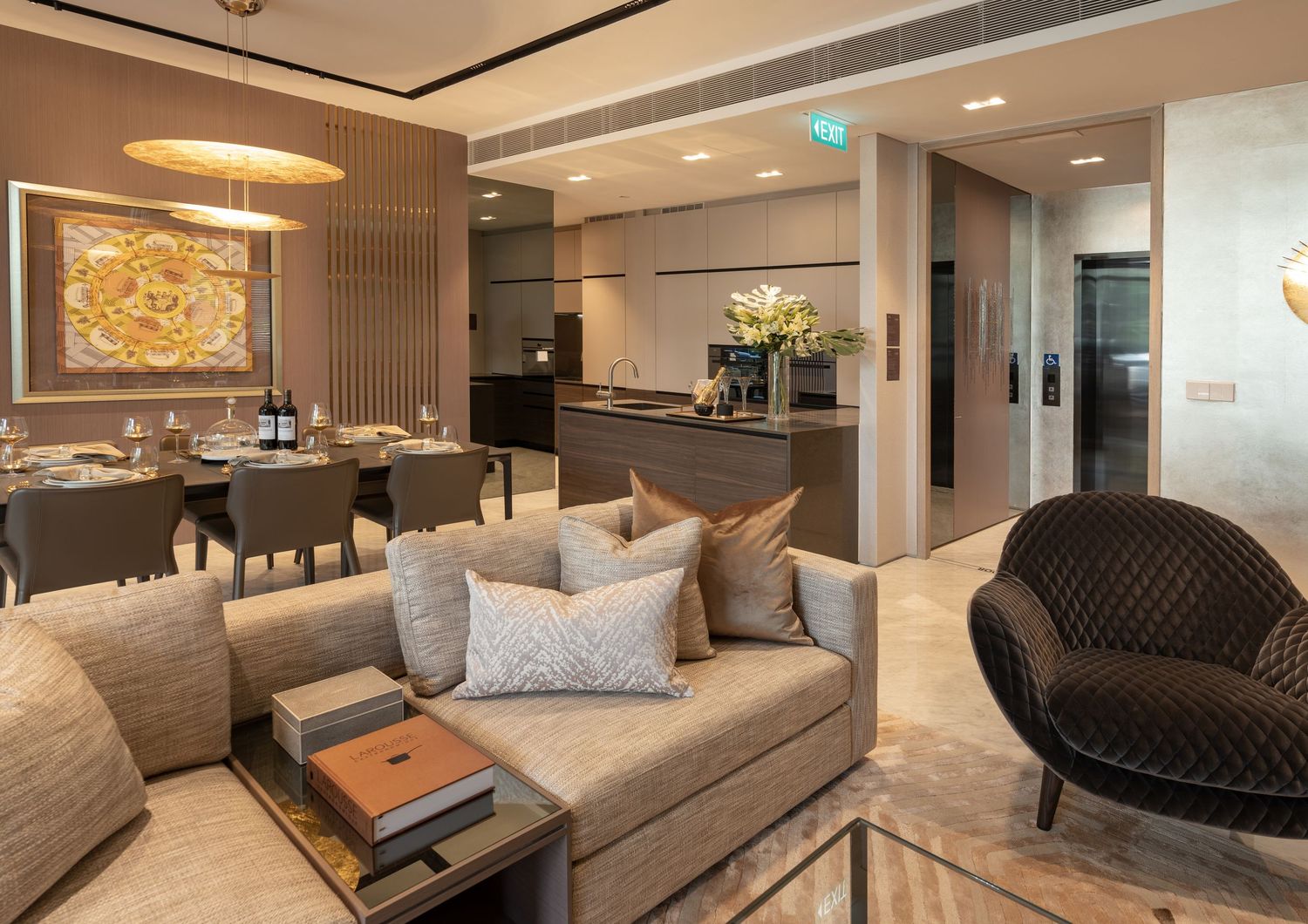 Elegant open-plan living room with beige sofa, dining area, and modern kitchen in a luxury apartment.