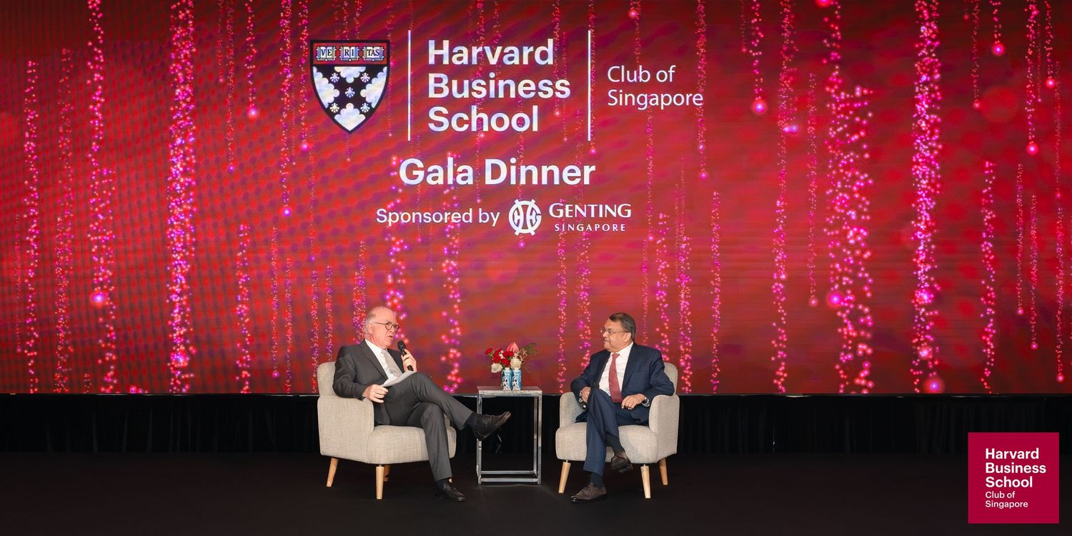 Harvard Business School Club of Singapore Gala Dinner sponsored by Genting, featuring two speakers on stage.