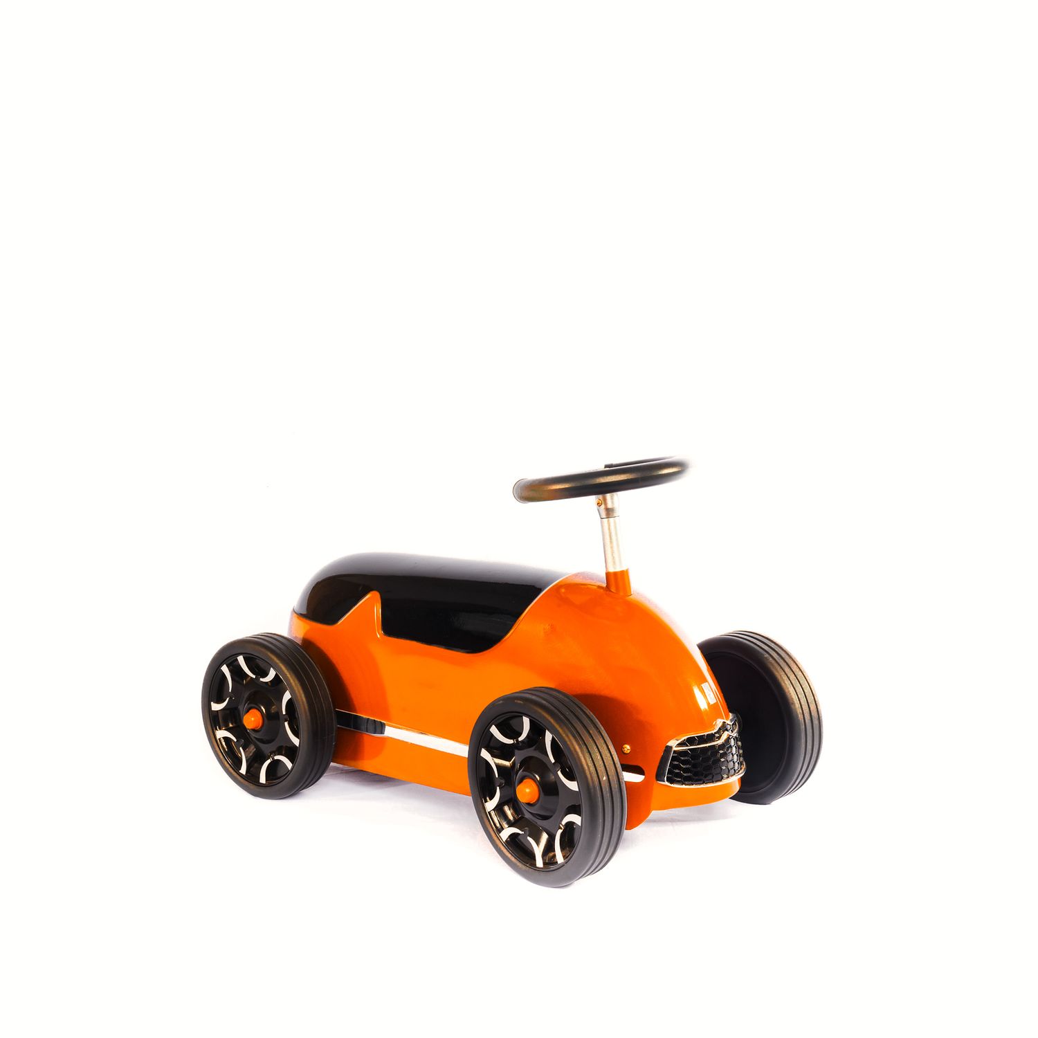 Stylish orange and black children's ride-on toy car with chrome steering wheel on white background.