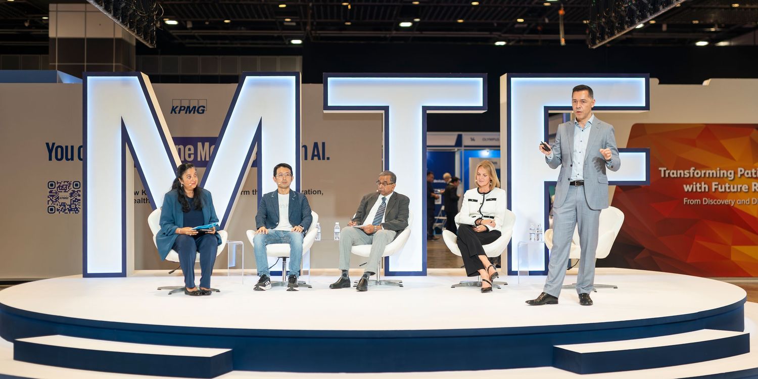 Five panelists on a modern stage at MTF conference discussing future technology transformation topics.