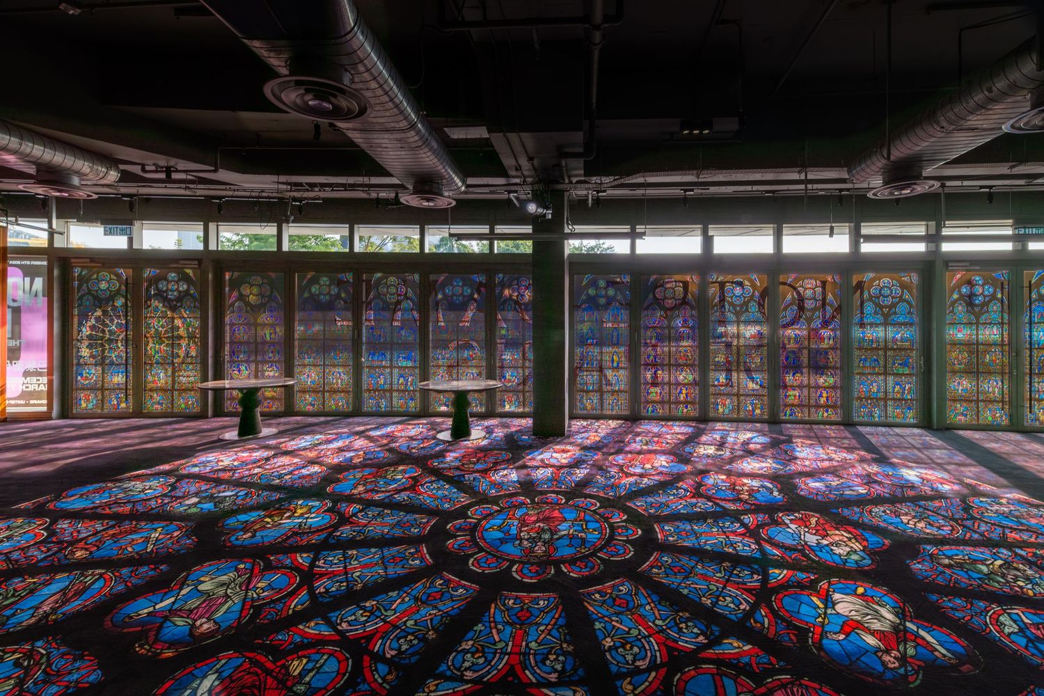 Stunning abandoned room with colorful stained glass windows casting vibrant light patterns on floor.