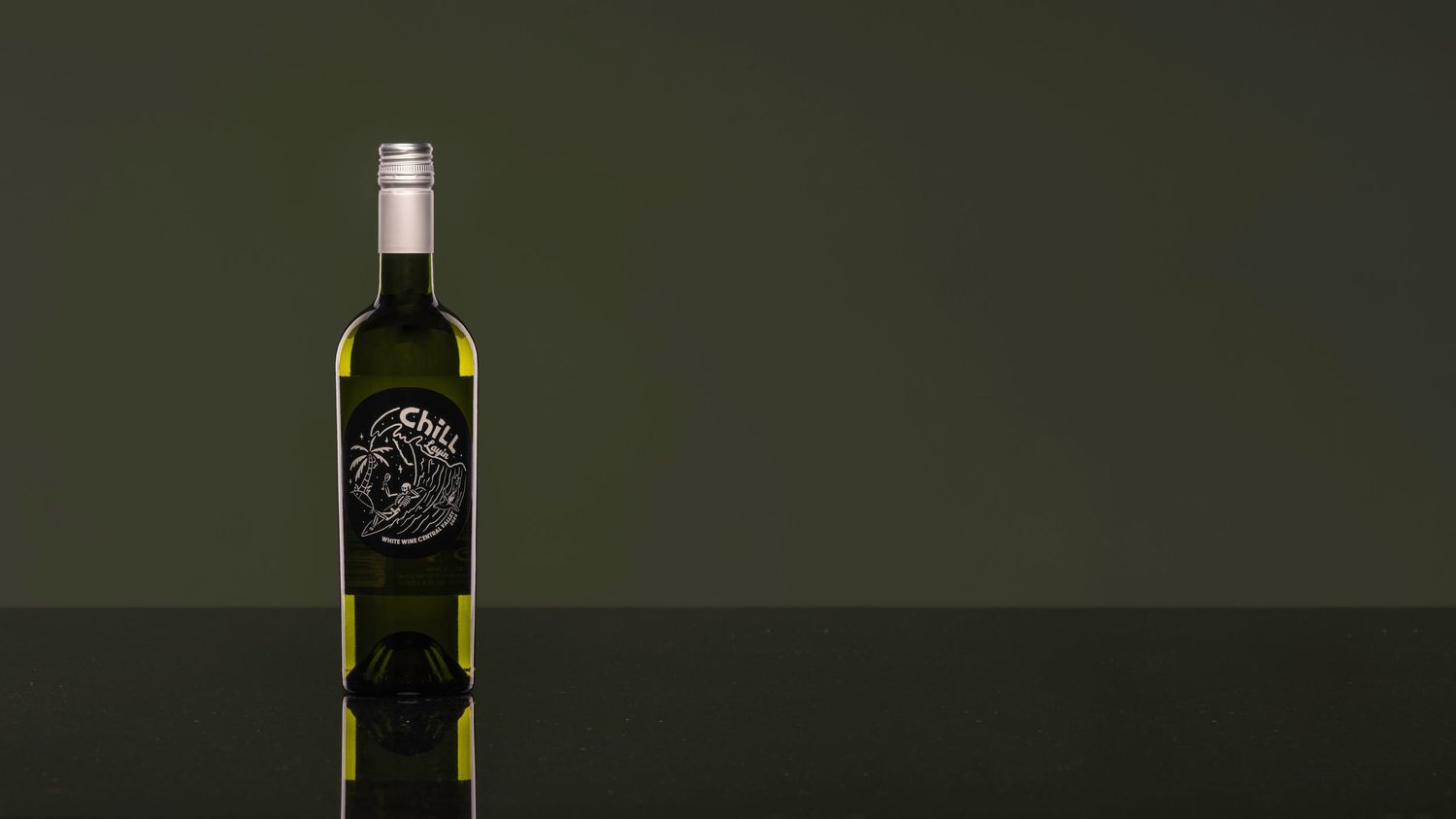 A sleek green wine bottle with a dark label featuring elegant white artwork, set against an olive green background.