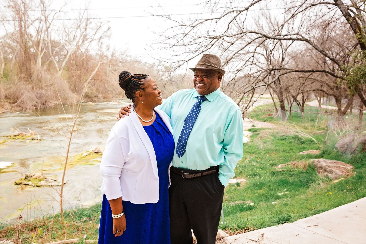 Couple sharing romantic moments together while walking outdoors in a natural setting.