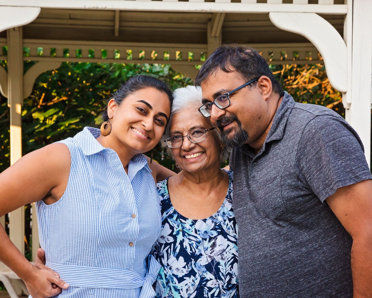 Group photo outdoors with people wearing casual attire and smiling together.