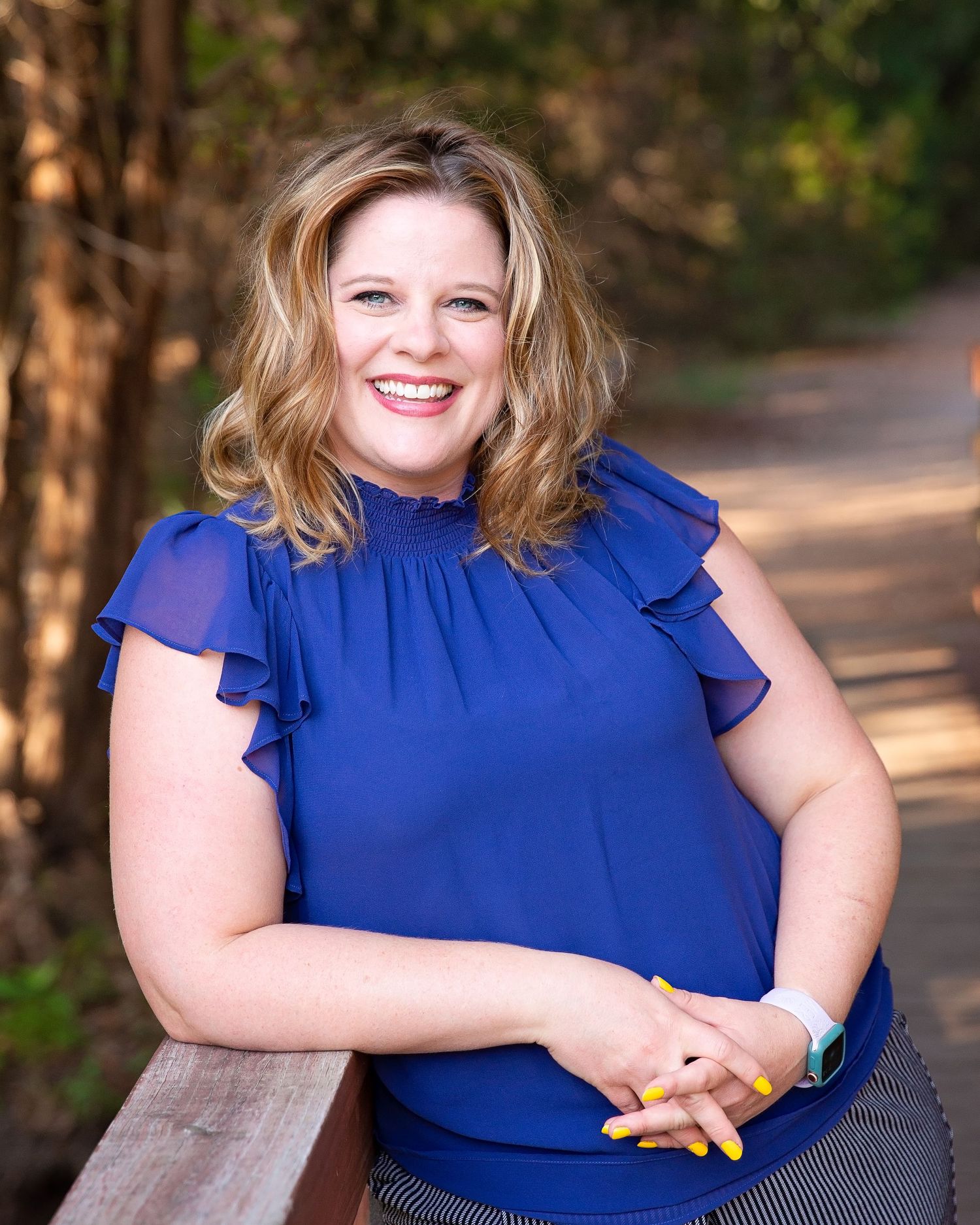 Outdoor portraits featuring a royal blue ruffled top against a natural background.