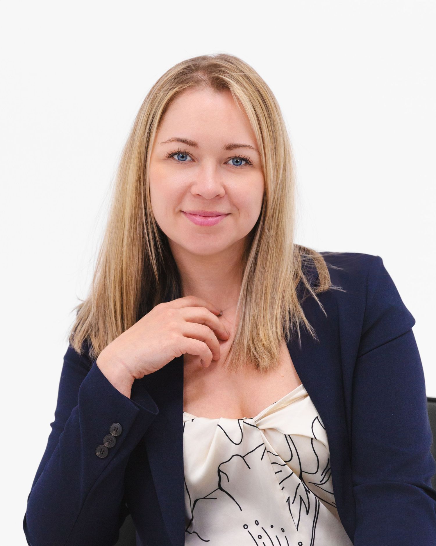 Professional portrait series in navy blazer and patterned top against white background.