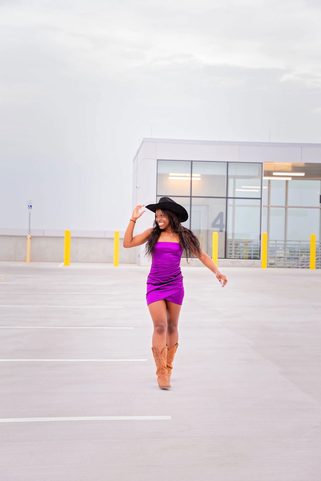 Dynamic dance poses in purple outfit against white urban background.