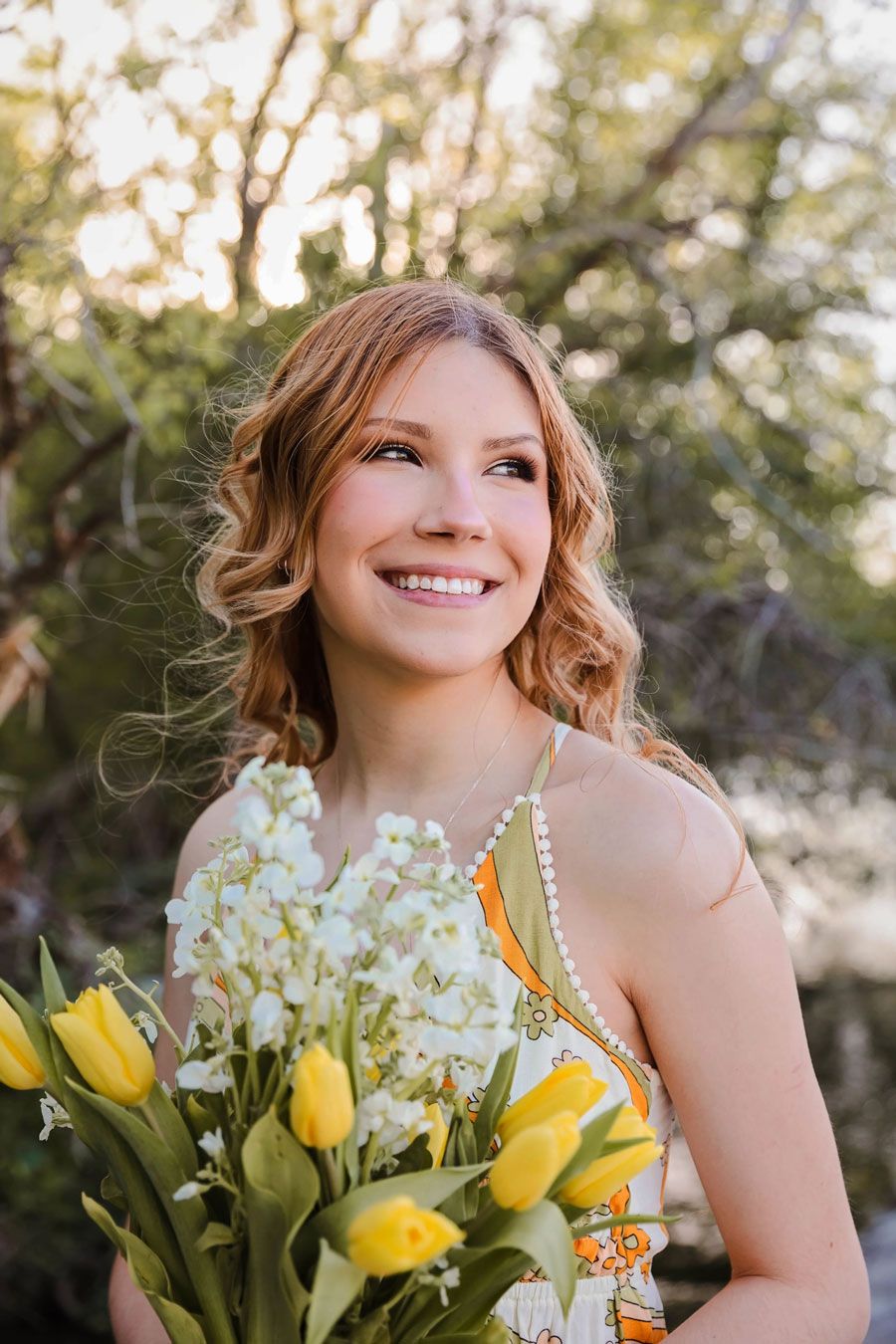 Spring portrait with yellow tulips and white flowers against a soft natural background.