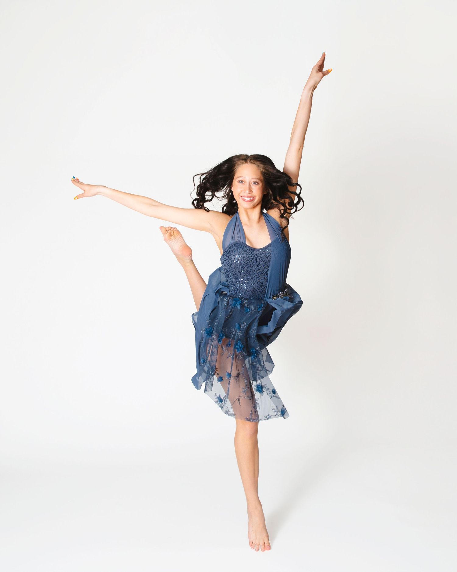Dynamic dance poses captured in blue costume against white studio background.