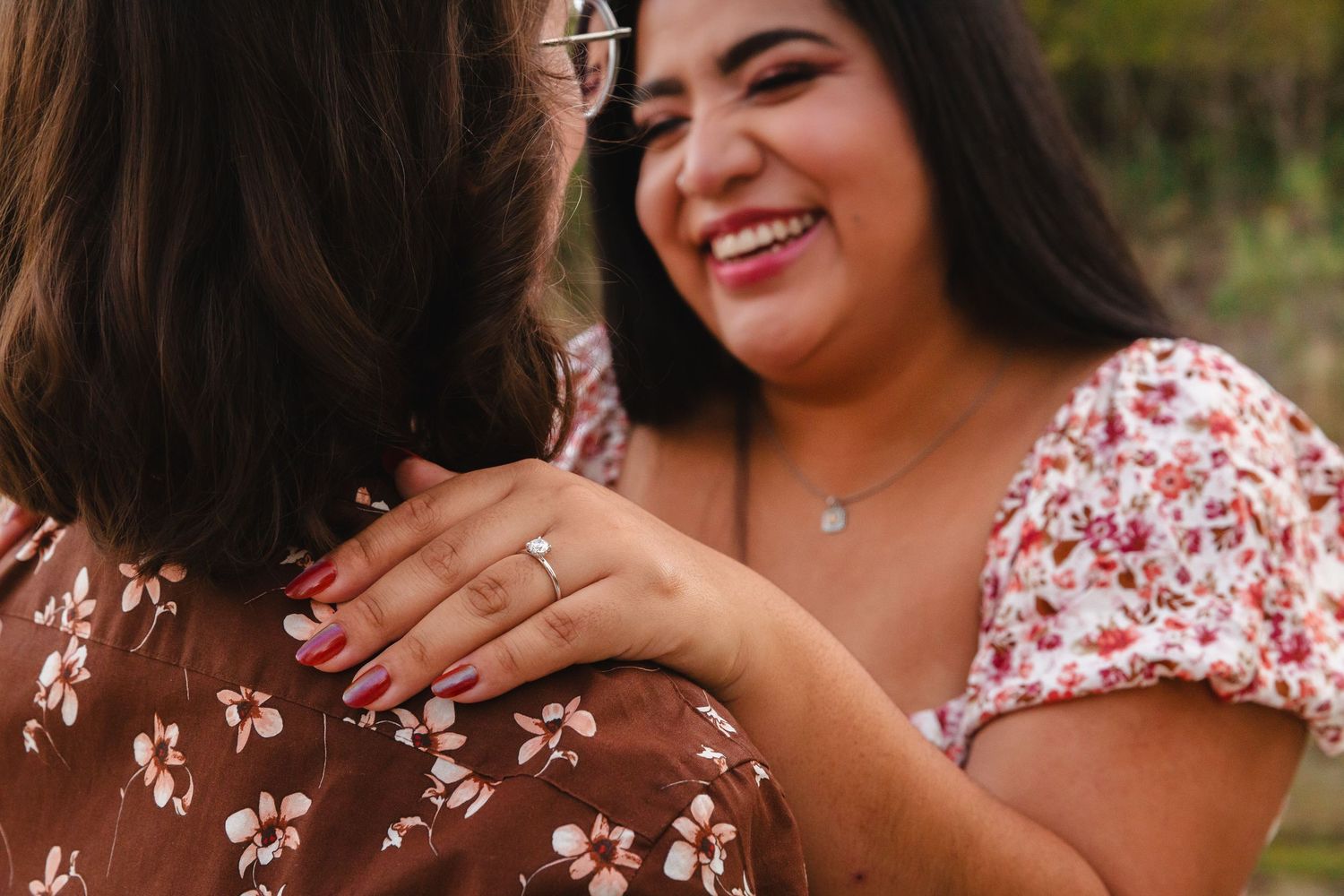 Couple shares joyful moment during outdoor portrait session in natural setting.