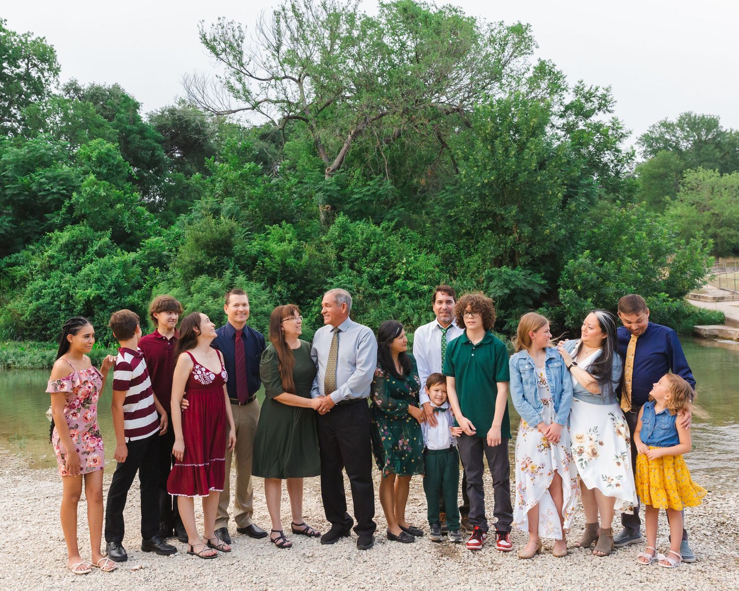 Large group photo taken outdoors with people lined up against a natural backdrop.