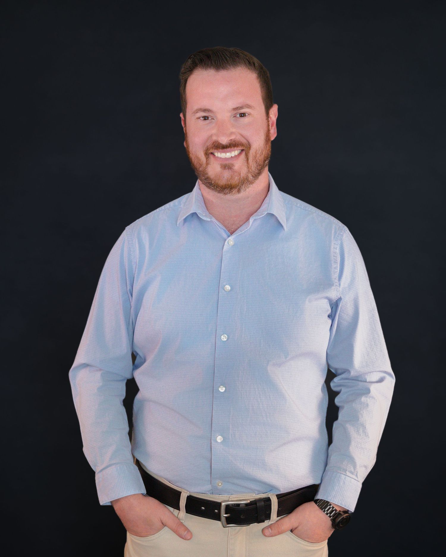 Professional headshots of person in light blue button-down shirt against dark background.