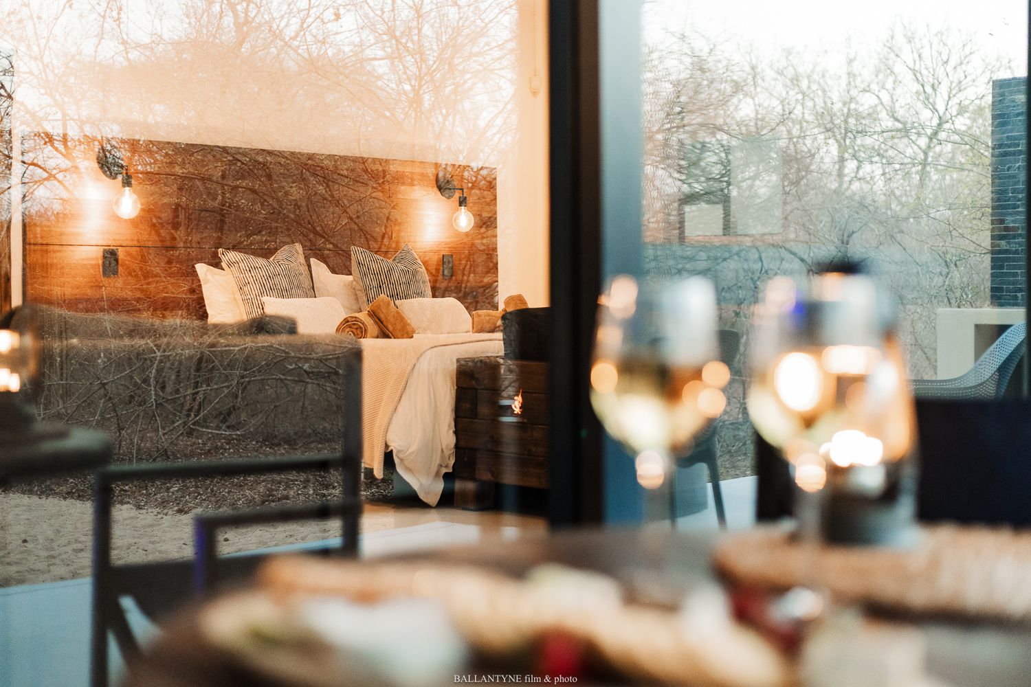 A cozy living room interior with warm lighting and decorative candles creating an inviting atmosphere.