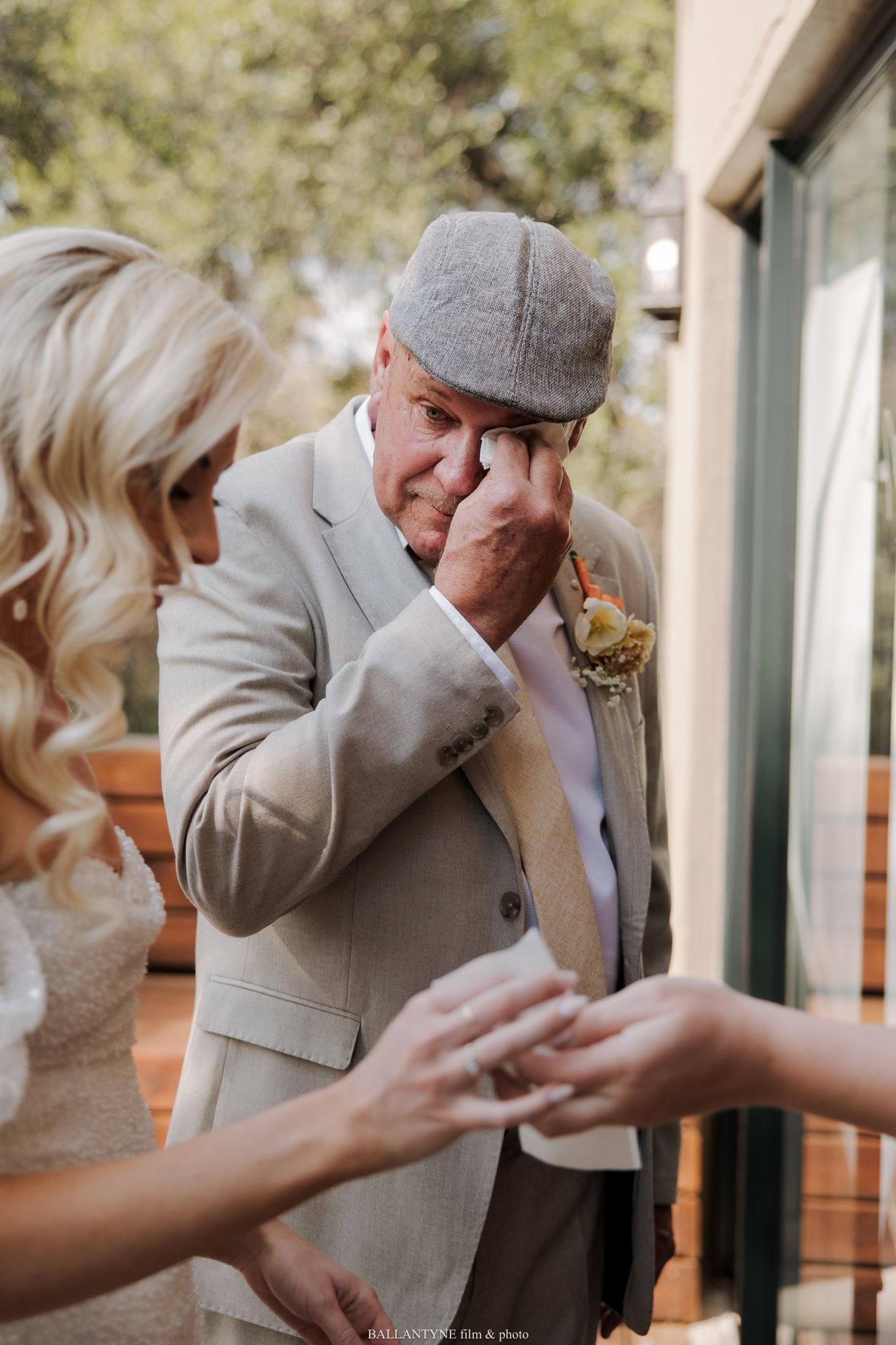 An emotional moment during a wedding ceremony as someone wipes away tears.