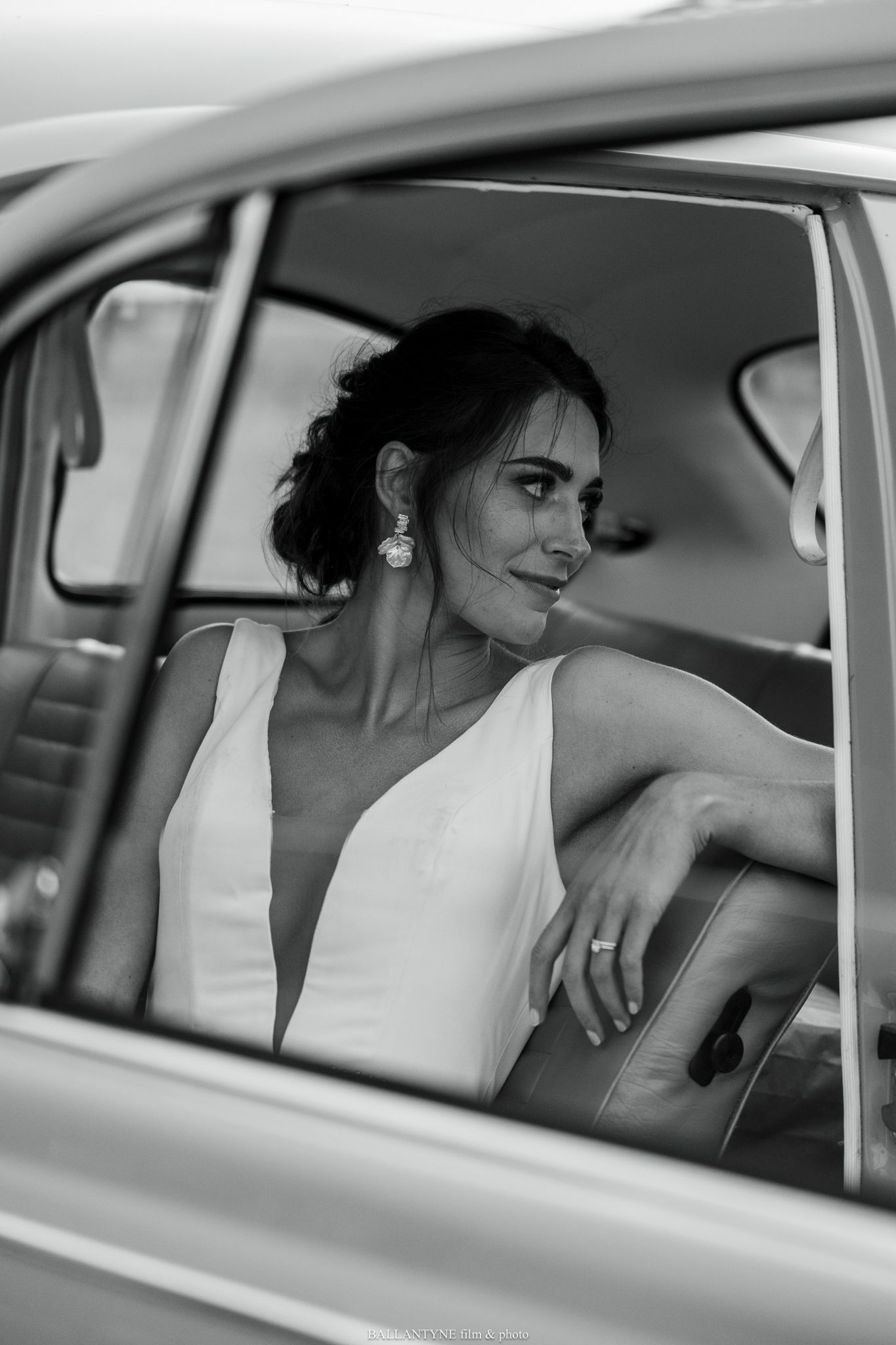 Black and white photo series of a bride sitting in a vintage car on her wedding day.
