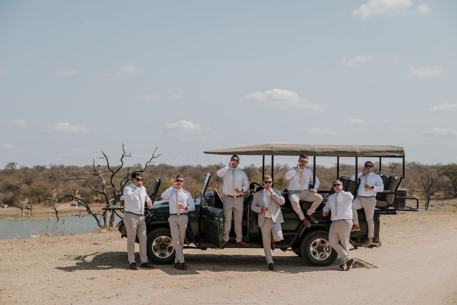 Outdoor desert wedding ceremony setup with guests seated under a canopy.