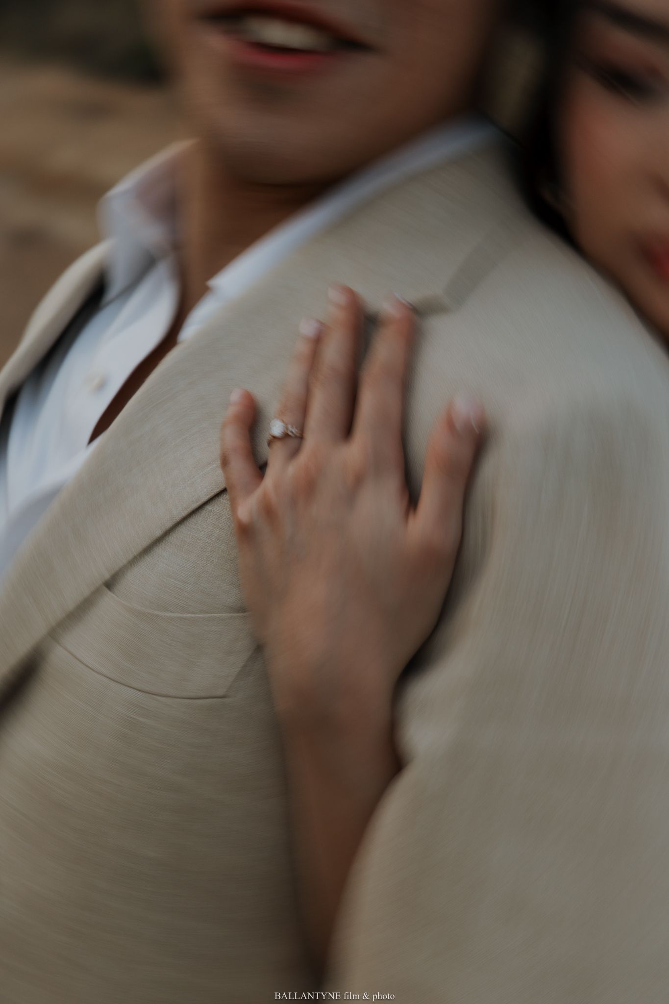 Close-up detail of hands gently touching in an intimate moment.
