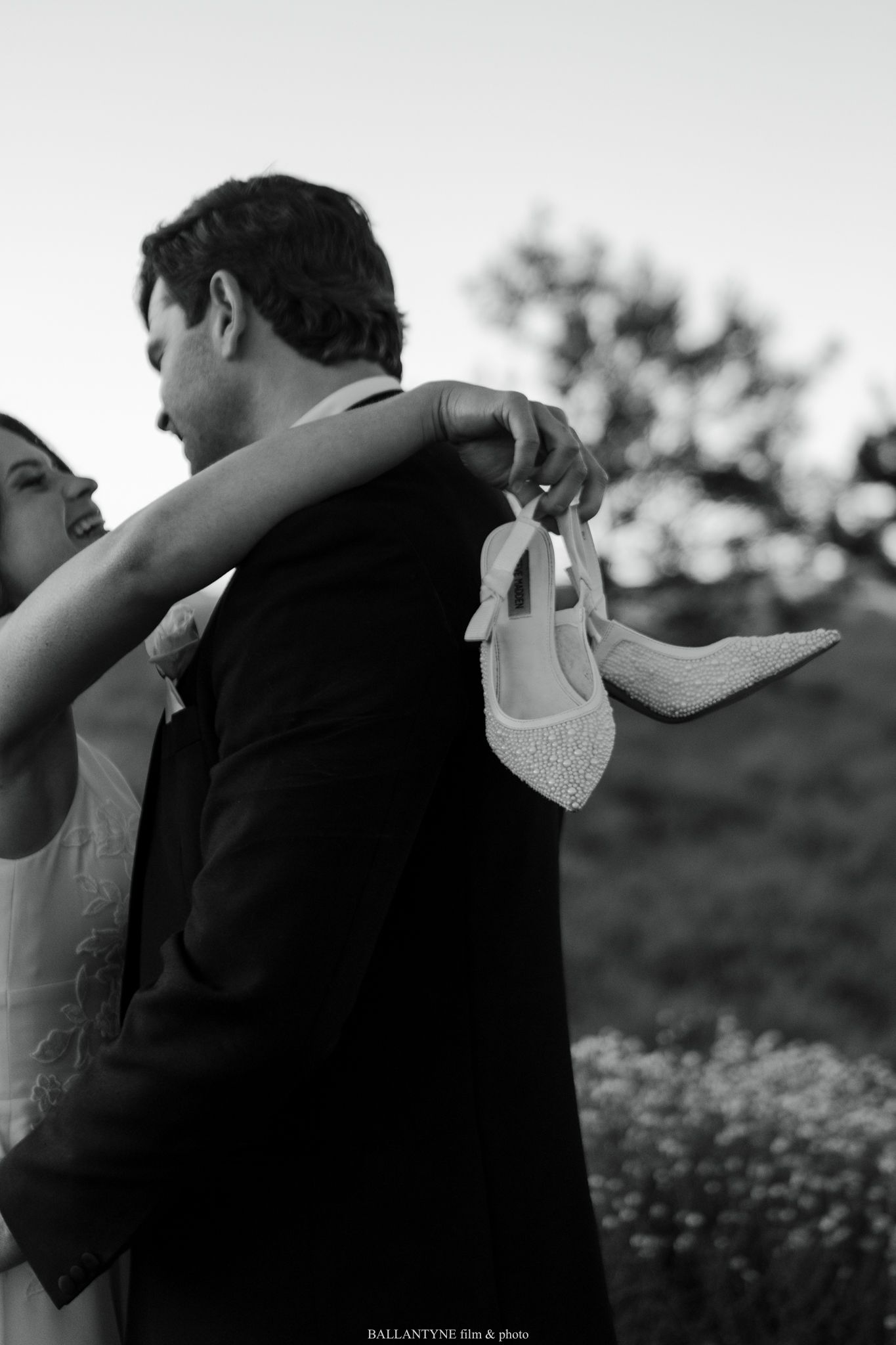 Black and white candid shots of a couple embracing during their wedding photoshoot.