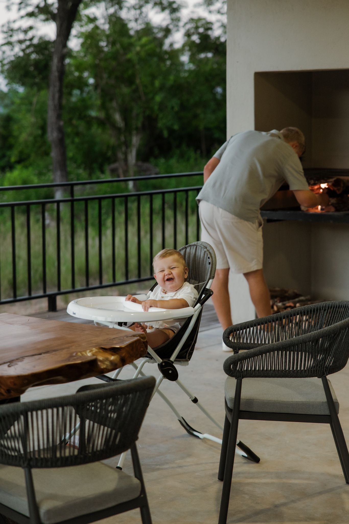 A sequence of photos showing a person cleaning an outdoor patio table with chairs at dusk.